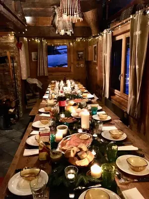a long table with candles and plates of food at Nos Maisons Cosy - Vallorcine in Vallorcine