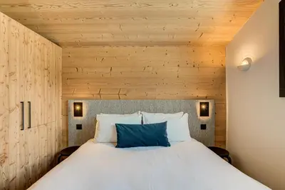 a bedroom with a bed with a wooden ceiling at Apartment Castorettes, Alpes Trave, Sleeps 6 to 7 in Chamonix-Mont-Blanc