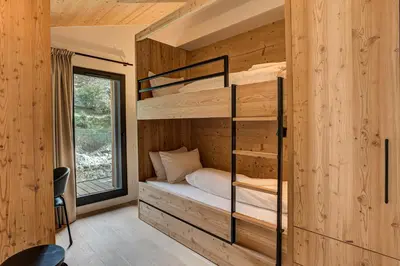 a bedroom with bunk beds in a log cabin at Apartment Castorettes, Alpes Trave, Sleeps 6 to 7 in Chamonix-Mont-Blanc