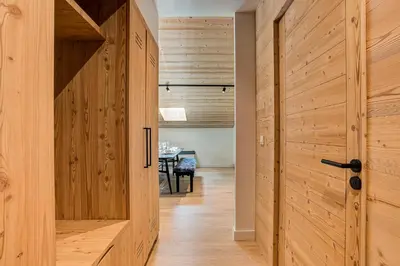 a hallway with a wooden door and a table at Apartment Castorettes, Alpes Trave, Sleeps 6 to 7 in Chamonix-Mont-Blanc