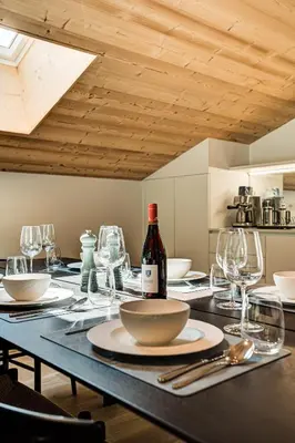 a table with glasses and a bottle of wine on it at Apartment Castorettes, Alpes Trave, Sleeps 6 to 7 in Chamonix-Mont-Blanc
