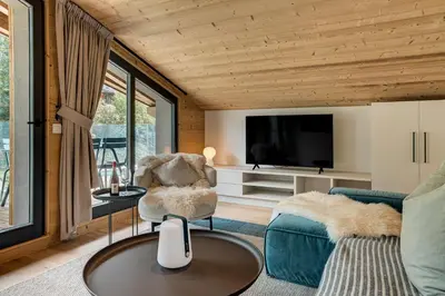 a living room with a couch and a tv at Apartment Castorettes, Alpes Trave, Sleeps 6 to 7 in Chamonix-Mont-Blanc
