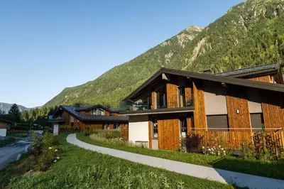 a resort building with a mountain in the background at Apartment Castorettes, Alpes Trave, Sleeps 6 to 7 in Chamonix-Mont-Blanc
