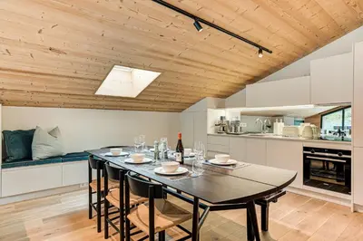 a dining room with a table and a kitchen at Apartment Castorettes, Alpes Trave, Sleeps 6 to 7 in Chamonix-Mont-Blanc