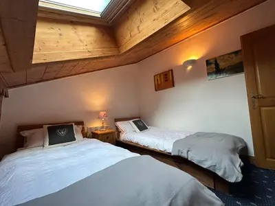 two beds in a room with wooden ceilings at Appartement confortable au pied des pistes pour 8 personnes - FR-1-642-104 in Morillon