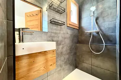 a bathroom with a sink and a shower at Refuge de la Fontaine in Megève