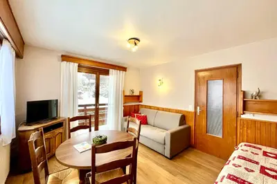 a living room with a table and a couch at Le Nid Étoilé - Mountain view in Combloux