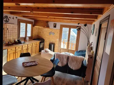 a kitchen and a table in a tiny house at Gîte de l Auguille in Megève