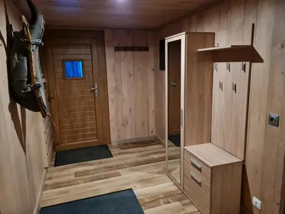 a small room with wooden walls and a door at Gîte de l Auguille in Megève