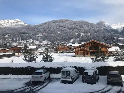 a group of cars parked in a parking lot in the snow at Samoëns studio 4 personnes idéalement situé in Samoëns