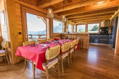 a dining room with a table with a red table cloth at Modern Chalet Near Megève With Somptuous Views in Combloux