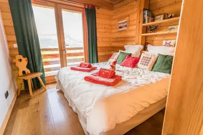 a bedroom with a bed in a log cabin at Modern Chalet Near Megève With Somptuous Views in Combloux