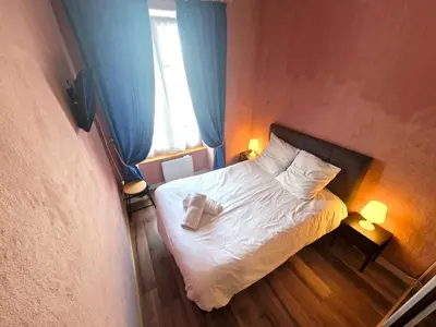 a small bedroom with a white bed with a window at Appartement Lyret, Chamonix Centre, 4 personnes in Chamonix-Mont-Blanc