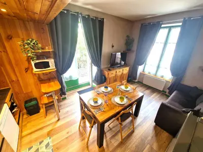 a living room with a table with dishes on it at Appartement Lyret, Chamonix Centre, 4 personnes in Chamonix-Mont-Blanc