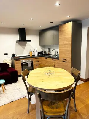 a kitchen and dining room with a wooden table at Le point de vue in Chamonix-Mont-Blanc