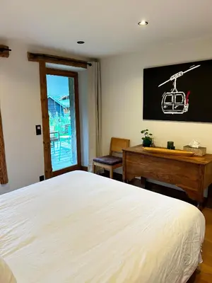 a bedroom with a bed and a desk and a chalkboard at Le point de vue in Chamonix-Mont-Blanc