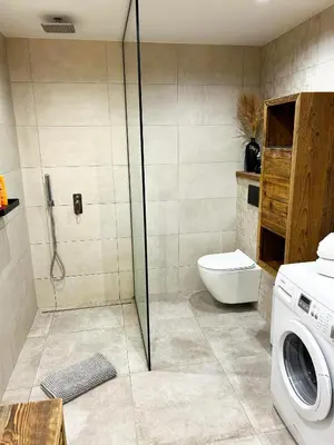 a bathroom with a shower and a washing machine at Le point de vue in Chamonix-Mont-Blanc