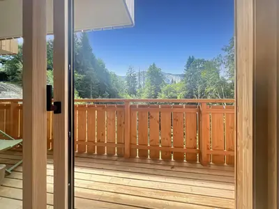 a view from the door of a deck at DBA202 - Appartement standing 4-5 pers in Les Carroz d'Araches