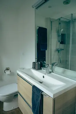 a bathroom with a sink and a toilet and a mirror at Le Perchoir d'Edmond in Chamonix-Mont-Blanc