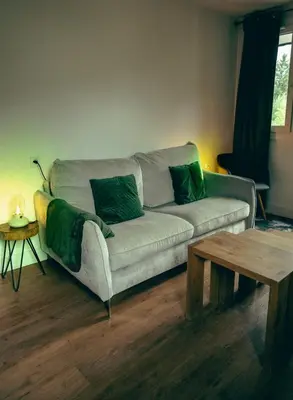 a living room with a couch and a coffee table at Le Perchoir d'Edmond in Chamonix-Mont-Blanc