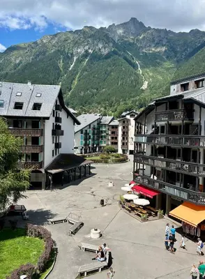 a group of buildings with mountains in the background at Le Perchoir d'Edmond in Chamonix-Mont-Blanc