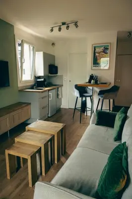 a living room with a couch and a table at Le Perchoir d'Edmond in Chamonix-Mont-Blanc