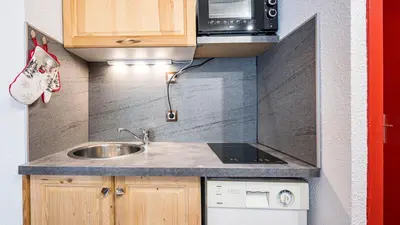 a small kitchen with a sink and a microwave at Grande Neige N 10 - 2P4 in Morillon