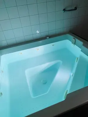 a bath tub with a blue light in a bathroom at Les 3 balcons du Mont Joly in Les Contamines-Montjoie