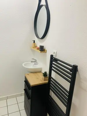 a bathroom with a sink and a mirror on the wall at Les 3 balcons du Mont Joly in Les Contamines-Montjoie