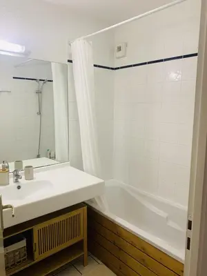 a bathroom with a white tub and a sink at Les 3 balcons du Mont Joly in Les Contamines-Montjoie