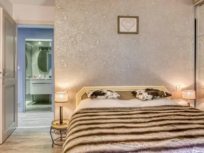 two dogs laying on a bed in a bedroom at Appartement 2 pièces pour 4 pers. à Megève avec Parking et Wifi, proche centre - FR-1-453-307 in Megève