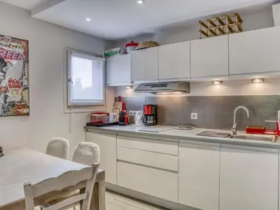 a kitchen with white cabinets and a dining table at Appartement 2 pièces pour 4 pers. à Megève avec Parking et Wifi, proche centre - FR-1-453-307 in Megève