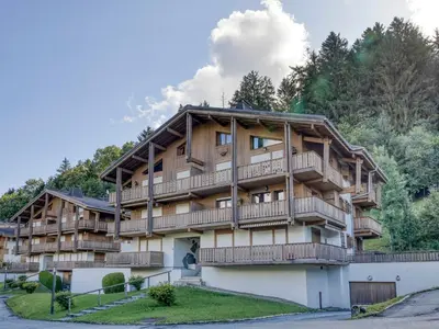 a large apartment building with balconies and trees at Appartement 2 pièces pour 4 pers. à Megève avec Parking et Wifi, proche centre - FR-1-453-307 in Megève