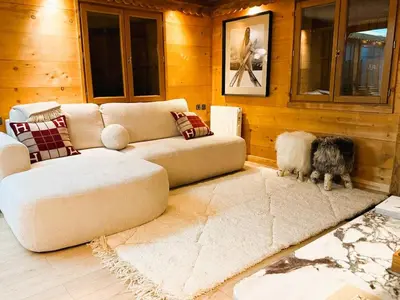 a living room with a couch and two dogs at Megève centre in Megève