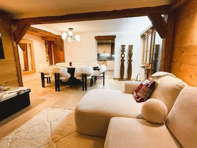 a living room with a couch and a table with chairs at Megève centre in Megève