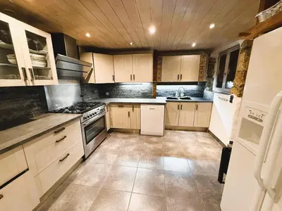 a kitchen with white appliances and wooden cabinets at Megève centre in Megève