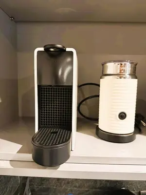 a black and white appliance on a shelf next to a blender at Megève centre in Megève
