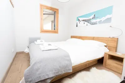 a bedroom with two beds and a window at Sauberands 18 apartment - Chamonix All Year in Chamonix-Mont-Blanc