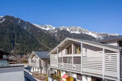 a row of houses with mountains in the background at Sauberands 18 apartment - Chamonix All Year in Chamonix-Mont-Blanc