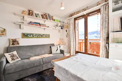a living room with a couch and a table at Étoile Front de Neige in Demi-Quartier