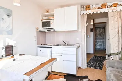 a kitchen with white cabinets and a sink at Étoile Front de Neige in Demi-Quartier