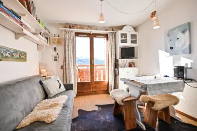 a living room with a couch and a table at Étoile Front de Neige in Demi-Quartier