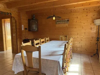 a dining room with a table and chairs in a cabin at Chalet typique 5 chambres pour 10 personnes avec Wi-Fi et terrasse - FR-1-572-303 in Arâches-la-Frasse