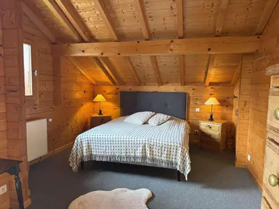 a bedroom with a bed in a wooden cabin at Chalet typique 5 chambres pour 10 personnes avec Wi-Fi et terrasse - FR-1-572-303 in Arâches-la-Frasse