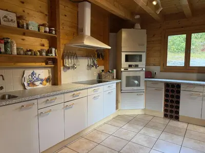a kitchen with white cabinets and a stove top oven at Chalet typique 5 chambres pour 10 personnes avec Wi-Fi et terrasse - FR-1-572-303 in Arâches-la-Frasse