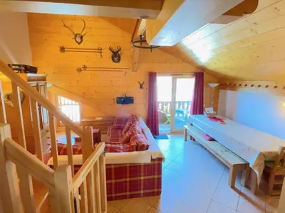 a room with a bed and a staircase in a wooden house at Appartement spacieux 70m², balcon, parking privatif, 6 personnes - FR-1-572-333 in Arâches-la-Frasse