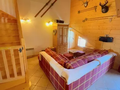a bed in a room in a log cabin at Appartement spacieux 70m², balcon, parking privatif, 6 personnes - FR-1-572-333 in Arâches-la-Frasse