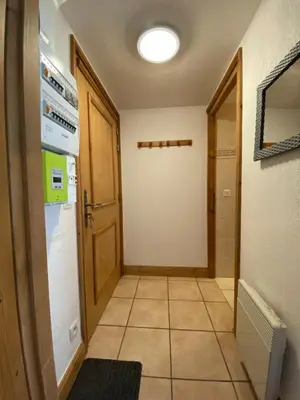 a hallway with a laundry room with a washer and dryer at Appartement 4-6 personnes centre Les Contamines Montjoie in Les Contamines-Montjoie