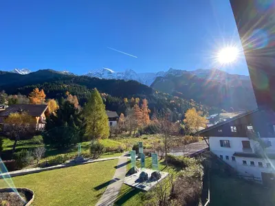 a view of a cemetery with the sun in the sky at Appartement 4-6 personnes centre Les Contamines Montjoie in Les Contamines-Montjoie