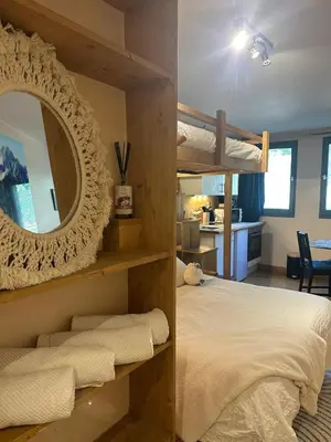 a bedroom with a bunk bed and a mirror at Nouveau Refuge de l aiguille in Chamonix-Mont-Blanc